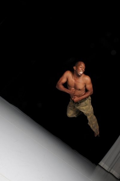 Boris Willis crouching low in a dynamic dance pose