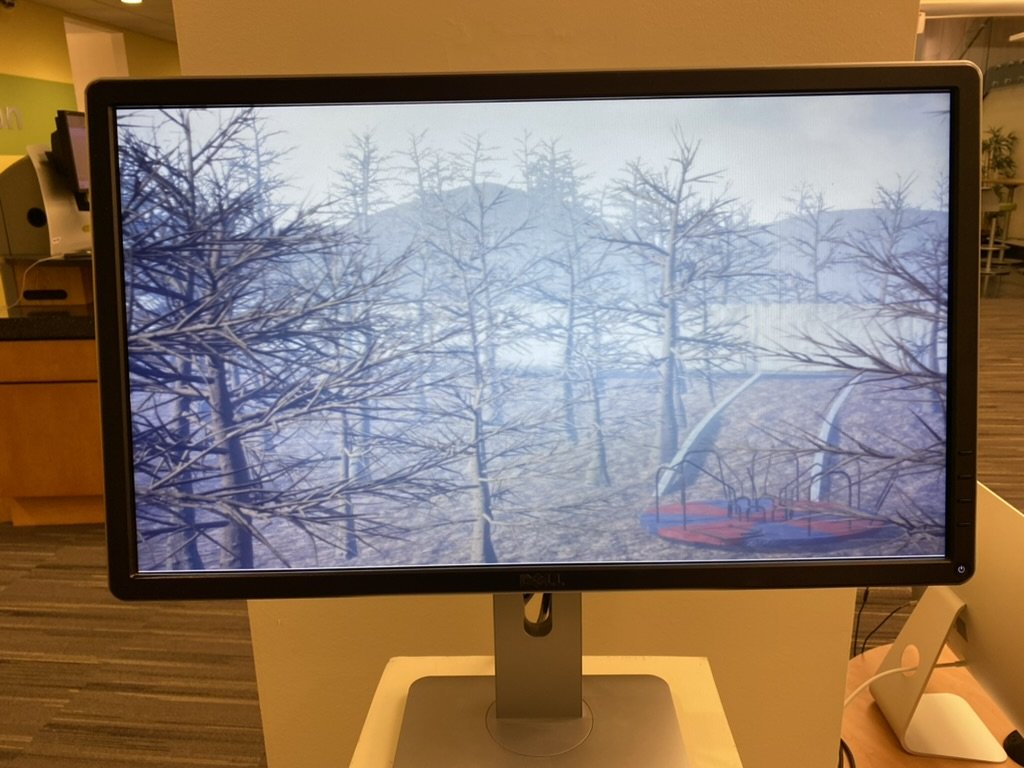A bare winter forest and distant hill rendered in Unreal Engine