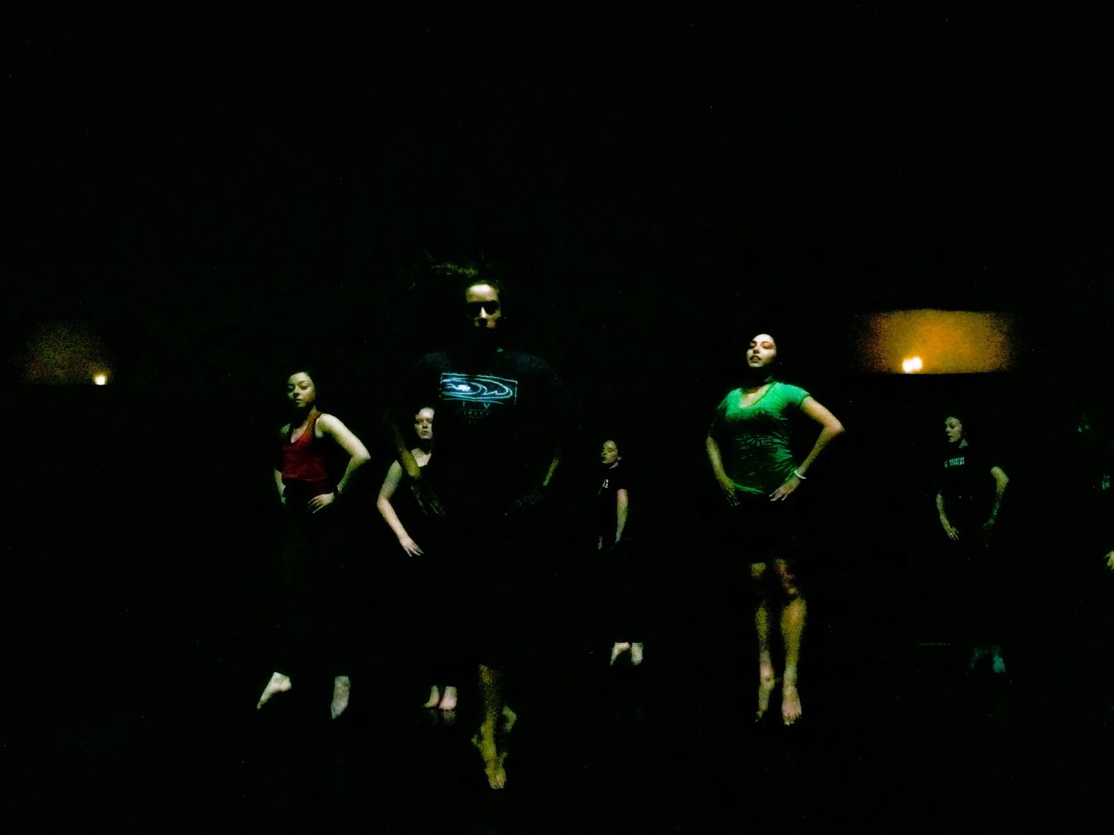 Dancers barely visible in a dark lighting state on the stage