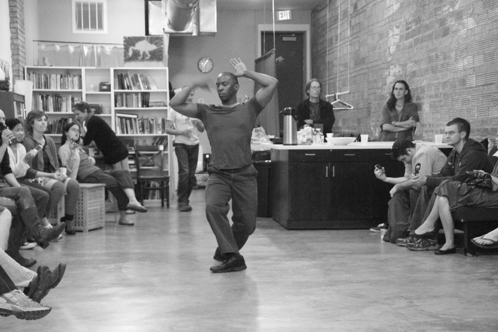 Boris Willis with both arms raised and crossing above his head