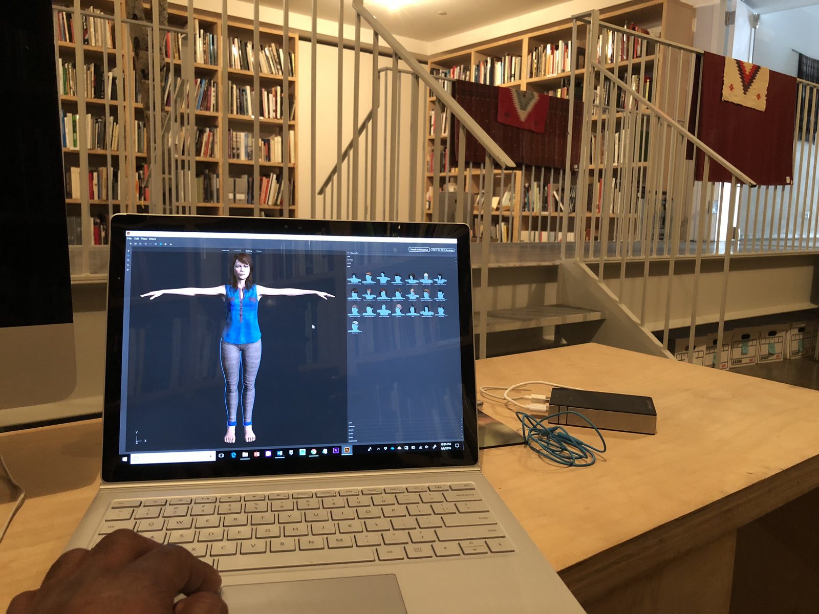 A laptop screen showing a motion-capture skeleton of a dancer